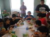 Sarosh in his familiar corner with his lunch, kids busy with their plates and Noshir standing up and eating